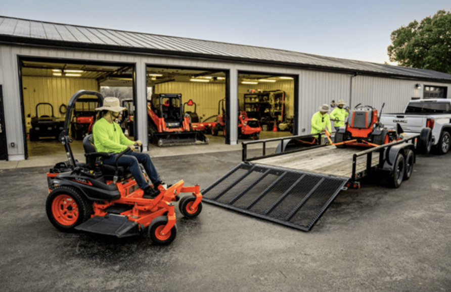 Loading mowers onto the back of a trailer