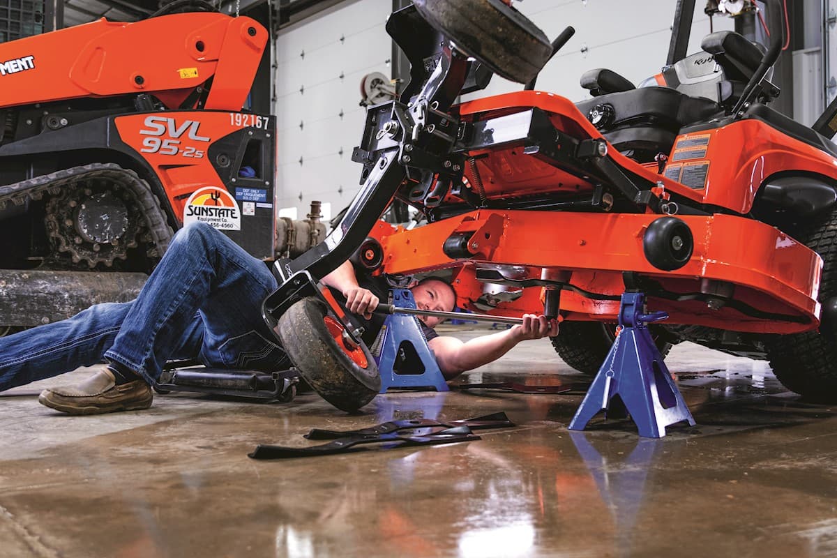 Technician working on a mower