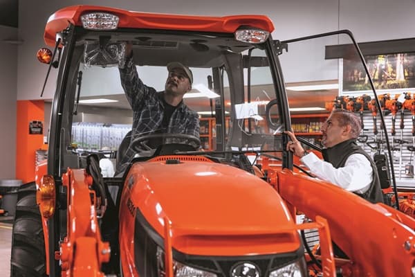 Customer checking out the inside of a tractor